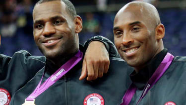 FILE - In this Aug. 12, 2012, file photo, Lebron James, left, and Kobe Bryant pose with their gold medals at the 2012 Summer Olympics in London. The Los Angeles Lakers have a new superstar - L.A.-Bron. The four-time NBA MVP announced Sunday night, July 1, 2018, that he has agreed to a four-year, $154 million contract with the Lakers. "Welcome to the family (at)KingJames," Bryant said on Twitter . "(hash)lakers4life (hash)striveforgreatness."
 (AP Photo/Charles Krupa, File)