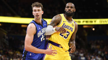 Mar 24, 2025; Orlando, Florida, USA; Orlando Magic forward Franz Wagner (22) guards Los Angeles Lakers forward LeBron James (23) in the second quarter at Kia Center. Mandatory Credit: Nathan Ray Seebeck-Imagn Images