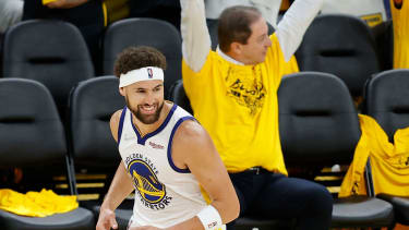 Golden State Warriors guard Klay Thompson (11) celebrates in front of owner Joe Lacob during the second half of Game 1 of basketball's NBA Finals against the Boston Celtics in San Francisco, Sunday, June 5, 2022. (AP Photo/John Hefti)