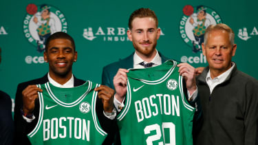 Boston Celtics' Kyrie Irving, left, and Gordon Hayward hold up their new jerseys with General Manager Danny Ainge, right, during a news conference in Boston, Friday, Sept. 1, 2017. (AP Photo/Winslow Townson)