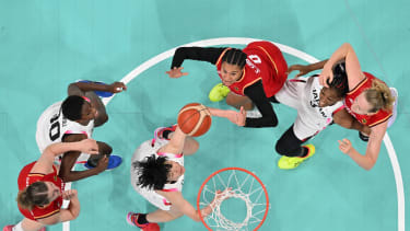 An overview shows Germany's #0 Satou Sabally (Top C) and Japan's #88 Himawari Akaho (3rdL) eye a rebound in the women's preliminary round group C basketball match between Japan and Germany during the Paris 2024 Olympic Games at the Pierre-Mauroy stadium in Villeneuve-d'Ascq, northern France, on August 1, 2024. (Photo by Sameer Al-DOUMY / POOL / AFP) (Photo by SAMEER AL-DOUMY/POOL/AFP via Getty Images)