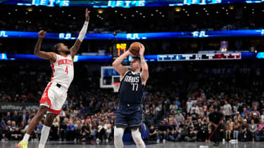 Houston Rockets' Jalen Green (4) defends as Dallas Mavericks' Luka Doncic (77) shoots during an NBA basketball game in Dallas, Thursday, Oct. 31, 2024. (AP Photo/Tony Gutierrez)