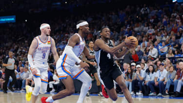 Dec 25, 2025; Oklahoma City, Oklahoma, USA; San Antonio Spurs guard De'Aaron Fox (4) drives to the basket beside Oklahoma City Thunder guard Shai Gilgeous-Alexander (2) during the second quarter at Paycom Center. Mandatory Credit: Alonzo Adams-Imagn Images