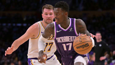 Dec 28, 2025; Los Angeles, California, USA; Sacramento Kings guard Dennis Schroder (17) drives past Los Angeles Lakers guard Luka Doncic (77) in the first half at Crypto.com Arena. Mandatory Credit: Jayne Kamin-Oncea-Imagn Images