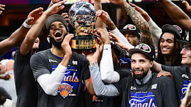 May 25, 2026; Cleveland, Ohio, USA; New York Knicks center Karl-Anthony Towns (32) and guard Jose Alvarado (5) help the team lift the trophy after defeating the Cleveland Cavaliers in game four of the eastern conference finals for the 2026 NBA playoffs at Rocket Arena. Mandatory Credit: Ken Blaze-Imagn Images